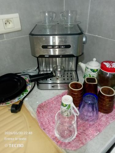 a kitchen counter with a coffee maker on a table at Dar MORTADA TATAOUINE in Tataouine