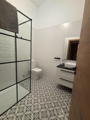 a bathroom with a toilet and a sink and a mirror at Mirador de Molinicos in Molinicos