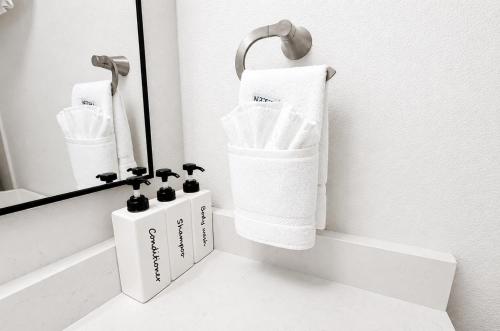 a bathroom with white towels and a mirror at Happy Harbor at Kimberling Crossing in Kimberling City