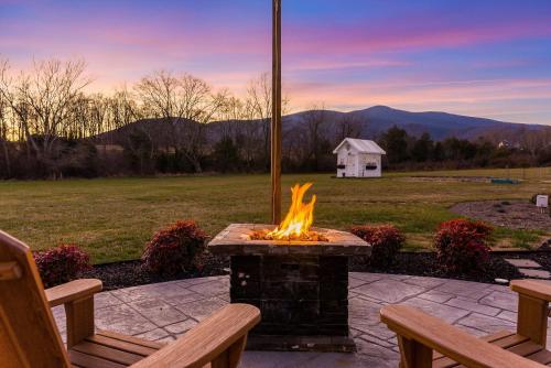 a fire pit on a patio with two benches at Afton Awaits in Afton