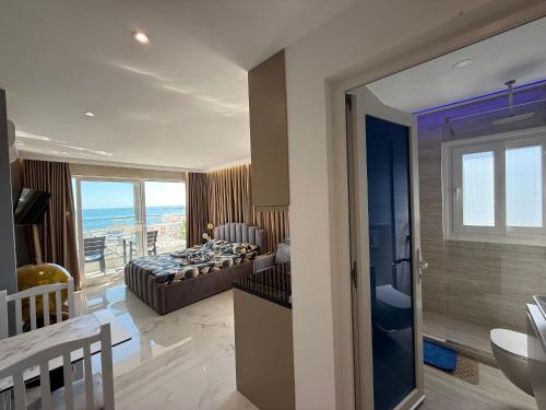 a bedroom with a bed and a view of the ocean at Eri Apartments in Durrës