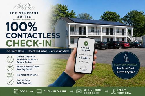 a person holding a cell phone in front of a house at Vermont Suites in South Burlington