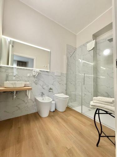 a white bathroom with two sinks and a shower at Porta Amari B&B in Palermo