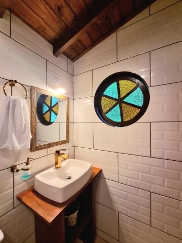 a bathroom with a sink and a window at Pousada Boutique Rancho Campanário in Rancho Queimado