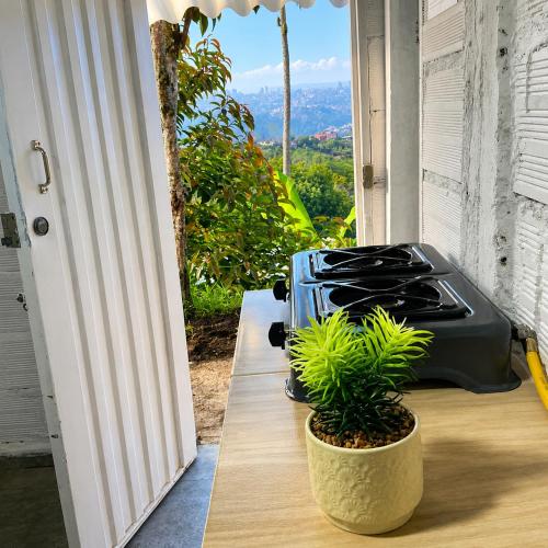 a suitcase sitting on a table next to a door at ECOHostal Las Hamacas El Mirador A Manizales in Villamaría