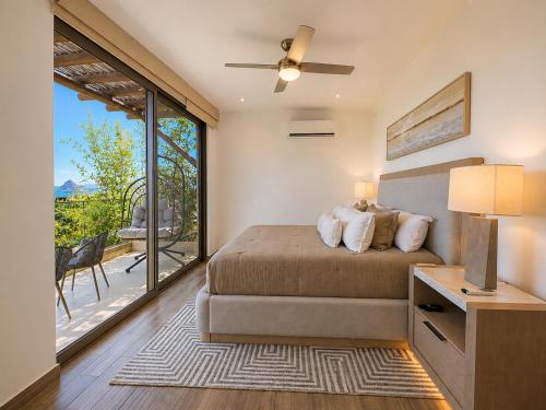 a bedroom with a bed and a large window at Casa Vista 133 in Cabo San Lucas