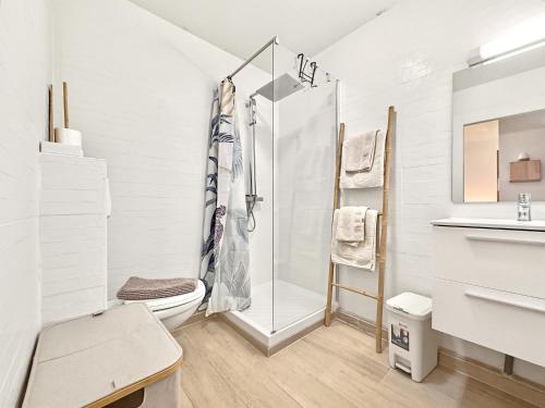 a bathroom with a shower and a toilet and a sink at Appart'hôtel DLOKOKO Sainte Luce centre in Sainte-Luce
