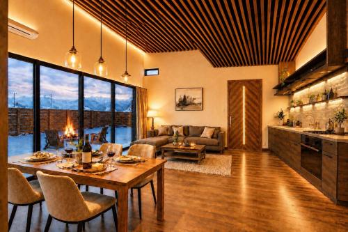 a living room with a table and chairs and a couch at 雪灯庵 in Iiyama