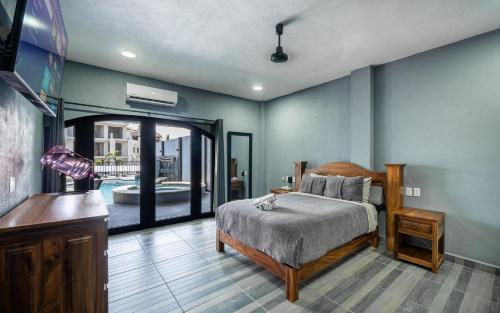 a bedroom with a bed and a view of a pool at Casa Del Toro in Barra de Navidad