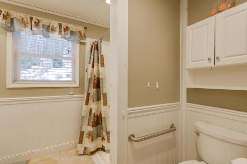 a bathroom with a toilet and a window at Waterfront Deck + Views: Schroon Lake Sanctuary in Schroon Lake