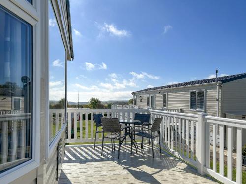 a porch with chairs and a table on a deck at Hamilton Unit 145 in Eyemouth