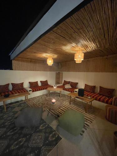 a large living room with couches and a table at Coastal Haven Surf Morocco in Aourir