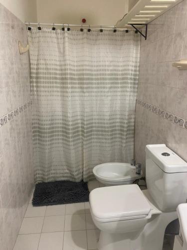 a bathroom with a toilet and a shower at Hogar in Río Gallegos