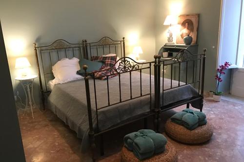 a bedroom with a bed with two hats on the floor at Dolce Farinella in Putignano