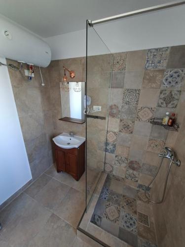 a bathroom with a shower and a sink at Apartamente VILLA 7 On The Beach in Eforie Nord