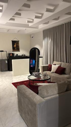 a living room with a couch and a tv at نزل سوم in Hail