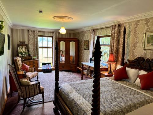 a bedroom with a bed and a table and chairs at Cavangarden House in Ballyshannon