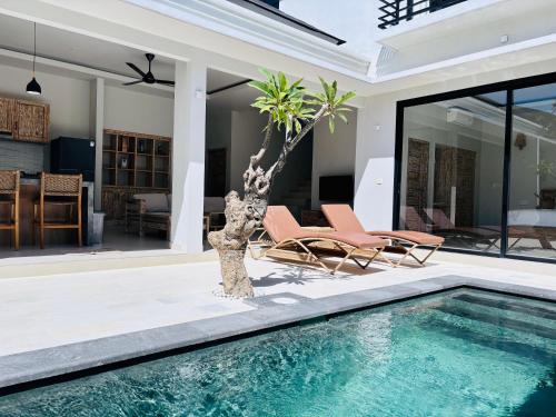 a villa with a swimming pool and a house at Lipah Beach Private Villas in Amed