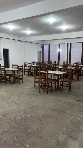 a room with wooden tables and chairs in a building at Pousada Fortaleza SP 8 in São Paulo