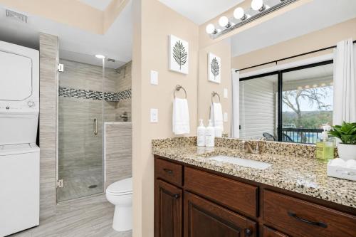 a bathroom with a sink and a toilet and a shower at The Perch at Kimberling Crossing in Kimberling City