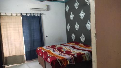 a bedroom with a bed with a colorful blanket at AC Room Double Bed 1st floor House in Mohali