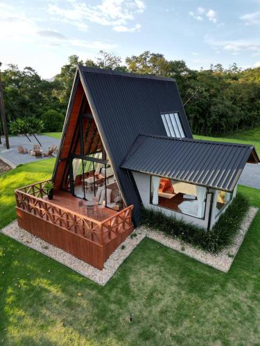 a rendering of a small house with a black roof at Chalés Aframe com café da manhã artesanal, 39km de Pomerode, Hidromassagem privativa, silenciosos em meio a natureza, lagoa para pesca esportiva in Massaranduba