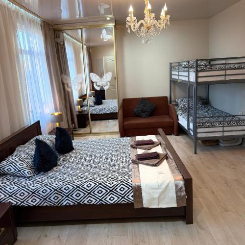 a bedroom with two bunk beds and a mirror at Vadim Home in Ventspils