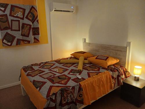 a bedroom with a bed with a quilt on it at Sucriers in Garnier
