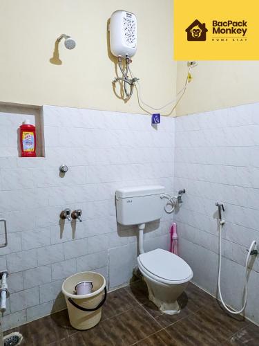 a bathroom with a toilet and a phone on the wall at Zapstays-Homestays in Visakhapatnam