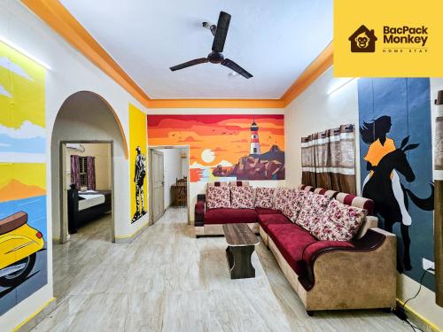 a living room with a couch and a bedroom at Zapstays-Homestays in Visakhapatnam