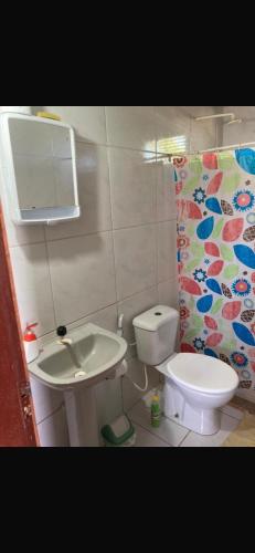 a small bathroom with a toilet and a sink at Paraíso Particular- Casa na Praia De Camurupim- Pedra Oca in Nísia Floresta