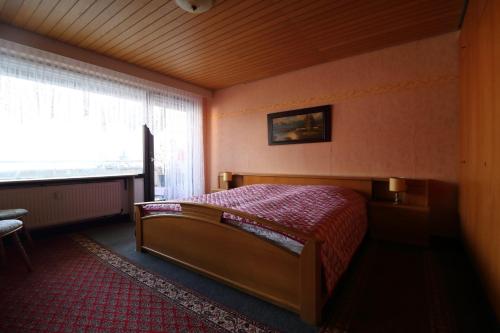a bedroom with a bed and a large window at Ferien Penthouse Panoramablick oder Studio Panoramablick in Bad Grund