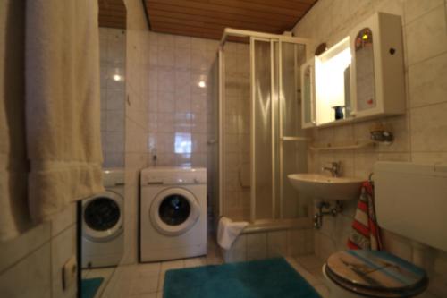 a bathroom with a washing machine and a sink at Ferien Penthouse Panoramablick oder Studio Panoramablick in Bad Grund