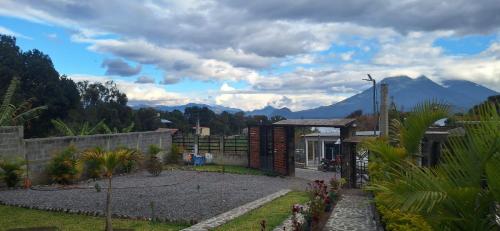 a house with a view of mountains in the background at HOTEL D&S Ch'umil in Tzununá