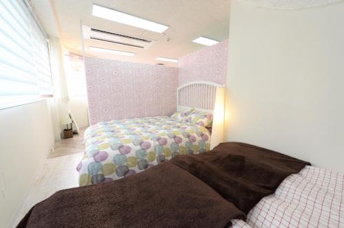 Ένα ή περισσότερα κρεβάτια σε δωμάτιο στο Sweet House Umeda Minami