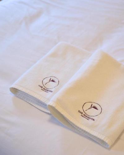 two white towels sitting on top of a table at The Mansion Pakchong in Pak Johng