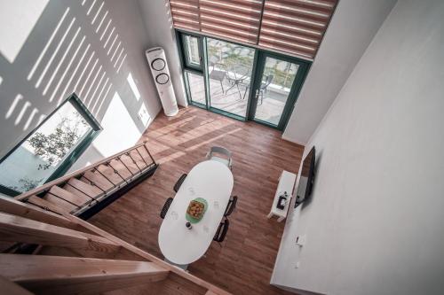 an overhead view of a living room with a boat on the floor at Poema Stay Pension in Jeju