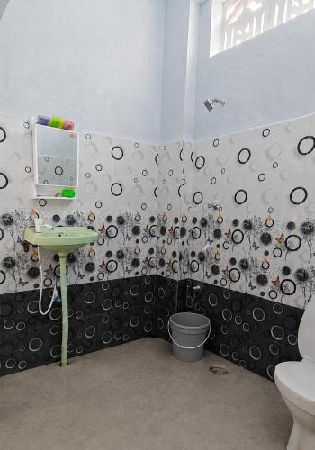 a bathroom with a toilet and a sink at Parisian Evenings Homestay - Madurai in Madurai