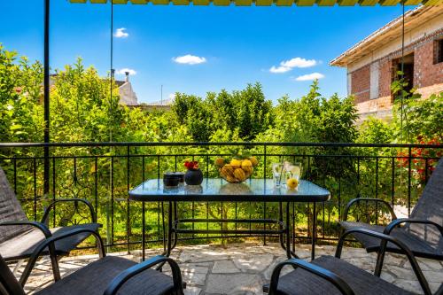 a table with fruit on top of a balcony at Efcharis house Skopelos in Neo Klima