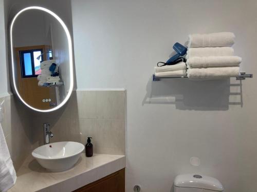 a bathroom with a sink and a mirror and towels at Casa Granada in Guanajuato