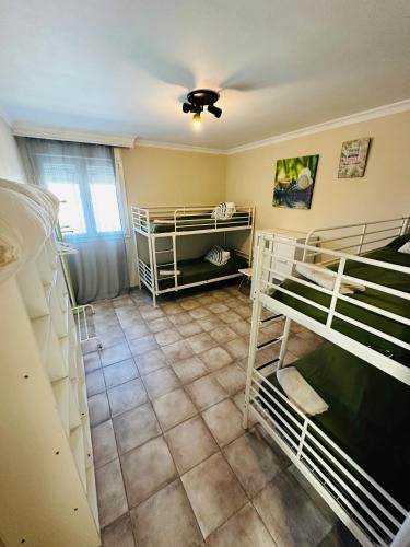 a room with three bunk beds and a ceiling at Casa Rural Vacacional in Puerto Real