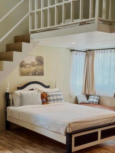 a bedroom with a large bed with a staircase at silverpine khao kho in Phetchabun
