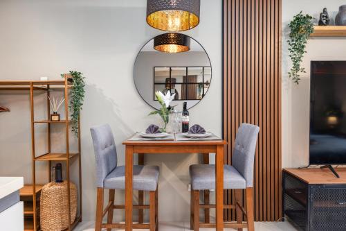 a dining room table with chairs and a mirror at Airport Haven Condotel - near Mactan-Cebu Airport 13 mins ride, Self Check-In, Wifi, Netflix, pool and Balcony view in Lapu Lapu City