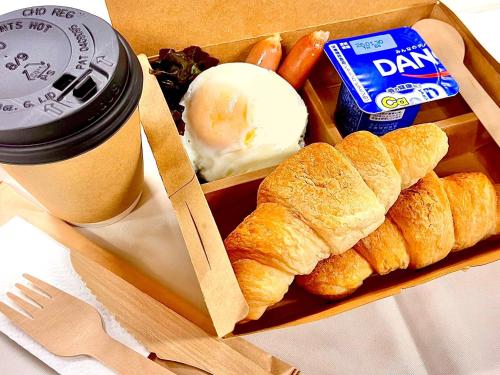 a tray of food with bread and eggs and a cup of coffee at APA Hotel Komatsu in Komatsu