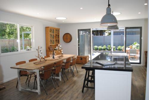 a kitchen and dining room with a table and chairs at Silverwood House in Woodend