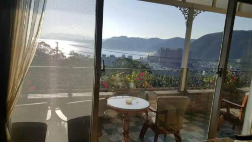 a view of a balcony with a table and chairs at Villa High Wharf in Wanli District