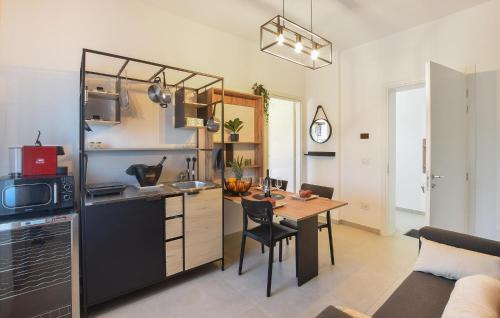 a kitchen with a table and a dining room at Le Vele - Contro Fiocco in Rosolina
