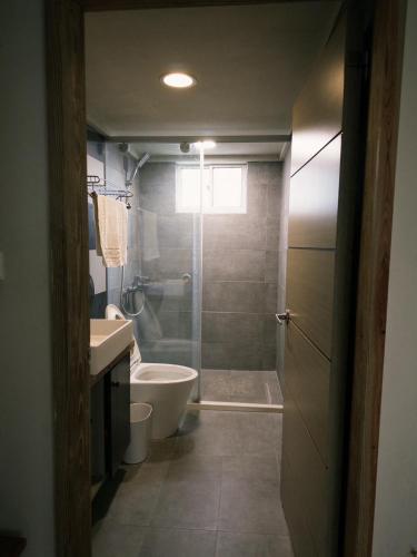 a bathroom with a shower and a toilet and a sink at 耶舍 yes sir 潛水旅宿1館2館 in Green Island