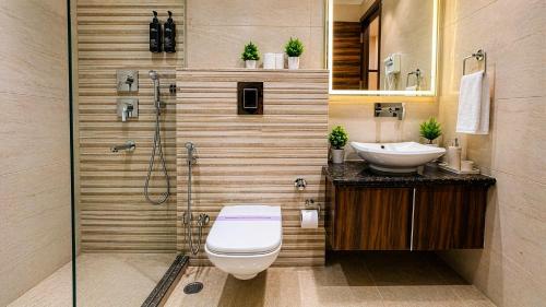 a bathroom with a toilet and a sink and a shower at Hotel Grand Regency by JMD Group Near Delhi IGI Airport in New Delhi