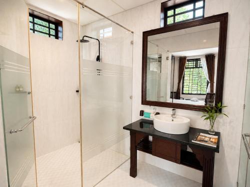 a bathroom with a shower and a sink and a mirror at Unity Villa Staycation -Self Checkin in Hoi An